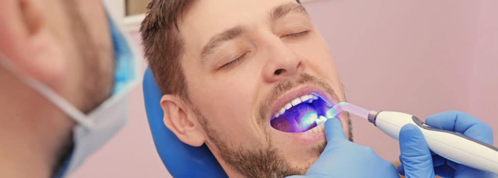 Dentist Examining Male Patient's Teeth — Your Holistic Dentists in Casuarina, NSW