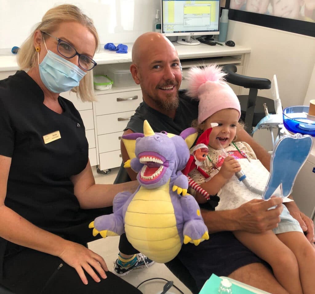 Little Girl With Her Father And A Dentist On A Dental Clinic